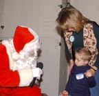 Santa greets a reluctant Cameron Hunt