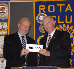 President Bill Peloquing presents check for $31,000 to Librarian Richard Pollard